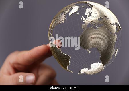 Male's hands holding an illustration of global network concept Stock Photo