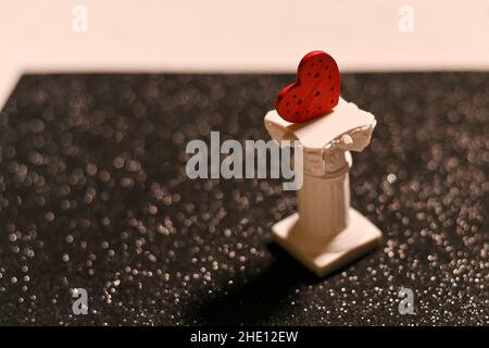 a heart on a concrete stand. black and white background Stock Photo