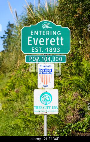 Everett, WA, USA - June 16, 2021; Green and white sign states Entering Everett with population number and signsTree City USA and All American Cit Stock Photo