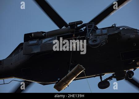 U.S. Army Staff Sgt. Anthony Marotta, right, and Sgt. Jeff Angle, UH-60L  Black Hawk helicopter crew chiefs with the New Jersey National Guard's  1-150th Assault Helicopter Battalion, conduct gear checks before hoist