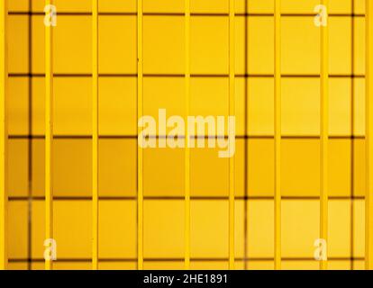 A yellow background of arranged lines with vertical yellow metal lines in U Weberwiese, Germany Stock Photo