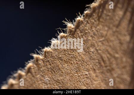 Macro shot detail of the surface of a textile fabric with a dark gray background Stock Photo