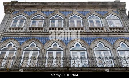 Facade embellished with traditional azulejo tiles on Rua Conselheiro Lopes da Silva along the Camino Portuguese in Valença, Portugal. This route of th Stock Photo