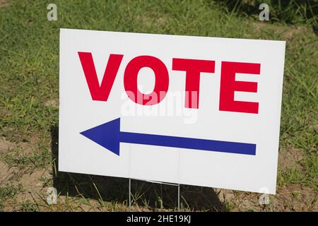 red white and blue vote sign with arrow pointing to the left Stock Photo