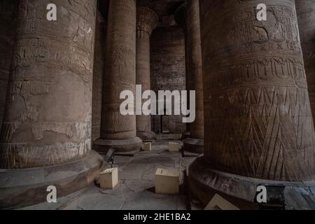 The interior of Edfu temple, a famous archeological site in Egypt. A room with carved stone columns, Stock Photo