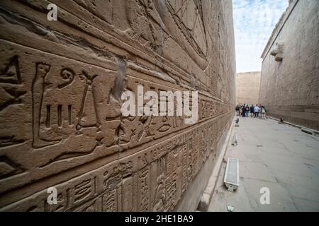 The inner passageway of Edfu temple covered with ancient relief sculptures and hieroglyphs, one of the most famous archeological sites in Egypt. Stock Photo