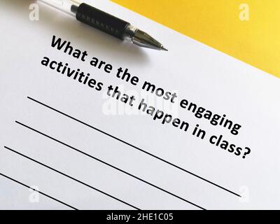 One person is answering question about remote learning.  The person is thinking what are the most engaging activities that happen in class. Stock Photo