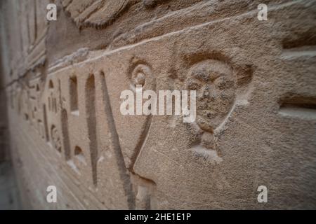 A small portrait hieroglyph on an ornately carved wall in the Karnak temple complex in Luxor, Egypt. Stock Photo
