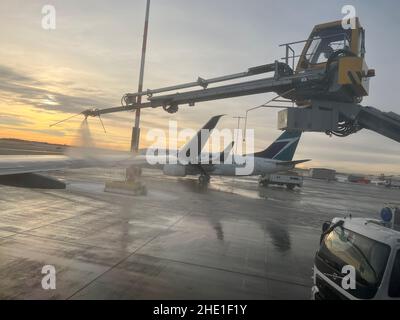 Calgary, Alberta, Canada - December 7, 2021: Westjet planes in Calgary YYC airport. The airport serves as headquarters for WestJet Airlines. Stock Photo