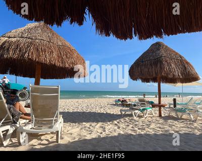 Playa del Carmen, Quintana Roo, Mexico - December 15, 2021: People enjoying the white sand tropical beach in Riviera Maya. Stock Photo