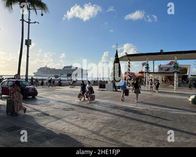 Cozumel, Quintana Roo, Mexico - December 17, 2021: San Miguel de Cozumel terminal for ferries going to Playa del Carmen. Tourists crossing street.