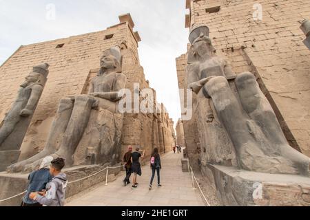 The entrance to Luxor temple, flanked by seated statues of King Ramses ...
