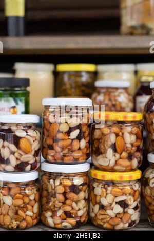 Nuts with honey in glass jars. Harvest of nuts. Delicacy and