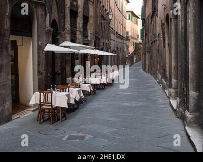 Siena, Tuscany, Italy - August 15 2021: Osteria Ristorante Gallo Nero in the Old Town of Siena Exterior Tables Stock Photo
