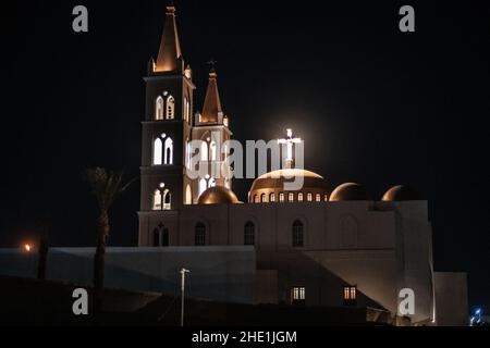 The St. Mary coptic orthodox church in Luxor, Egypt lit up at night. The church is the oldest coptic church in the city. Stock Photo