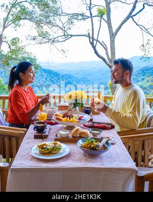 top view of a luxury breakfast in the mountains of Chiang Mai Thailand, luxury breakfast with Chiang Mai curry noodle soup or Khao soi gai , couple having breakfast, man and woman Stock Photo