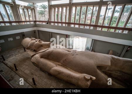 A giant statue of Rameses II, an Egyptian pharaoh lies in the museum built to display it in Memphis, Egypt. Stock Photo