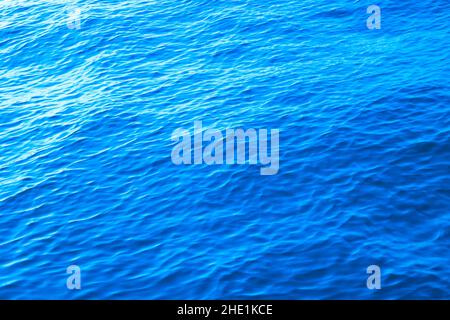 Blue calm sea. Calm sea background photo with little waves. Abstract background of water surface. Stock Photo