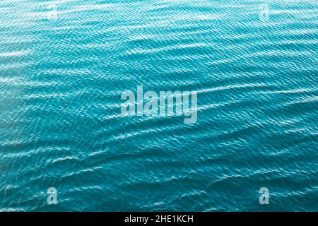 Sea background. Calm sea with little waves abstract background photo. Water surface texture. Stock Photo