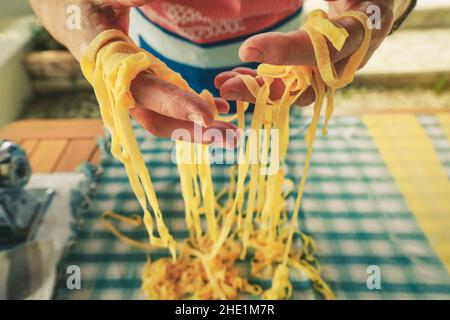 homemade Italian pasta, hands of a person making fresh pasta Stock Photo
