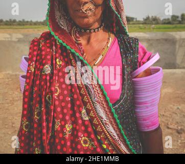 Helf face of Indian Rajasthani woman wearing traditional colourful clothing and jewellery Stock Photo