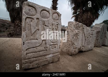 An ancient stone slab with egyptian hieroglyphs carved on it sits outside in Memphis, Egypt. Stock Photo