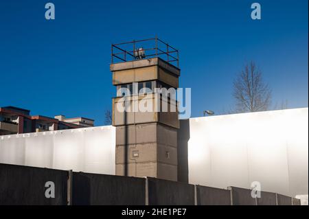 06.01.2022, Berlin, Germany, Europe - Monument of the Berlin Wall Memorial with watchtower, concrete wall segments and steel wall at Bernauer Strasse. Stock Photo