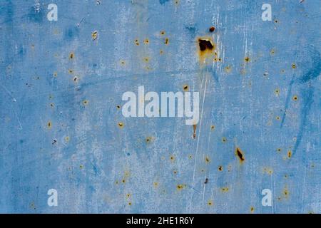 Close-up shot of a blue metallic wall with rust on it Stock Photo