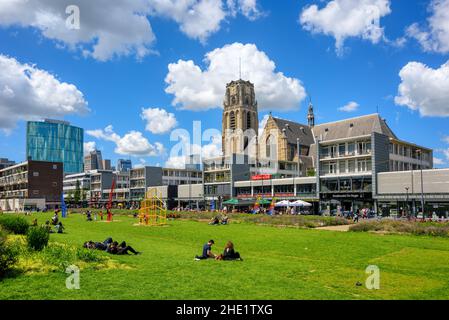Rotterdam, Netherlands - 20 July 2020: Green lawn with view of Laurenskerk church is a popular recreational location in Rotterdam city center, South H Stock Photo
