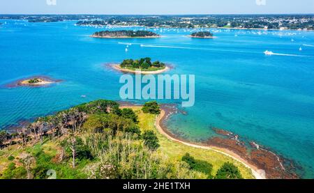 Small islands scattered in the blue water of the Gulf of Morbihan on atlantic coas of Brittany, France Stock Photo