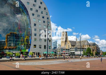 Rotterdam, Netherlands - 20 July 2020: The modern Markthal building and historical Laurenskerk church are prominent landmarks in the Rotterdam city ce Stock Photo