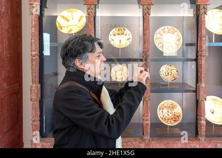 Senior Latin American woman browsing the exhibits. The Aga