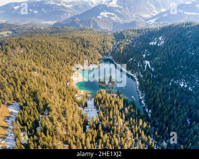 Aerial image of the Caumasee Lake with the overview into the valley in late autumn and early winter season Stock Photo