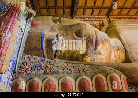 ZHANGYE, CHINA - AUGUST 23, 2018: Reclining Buddha in Giant Buddha Dafo Temple in Zhangye, Gansu Province, China ZHANGYE, CHINA - AUGUST 23, 2018: Reclining Buddha in Giant Buddha Dafo Temple in Zhangye, Gansu Province, China