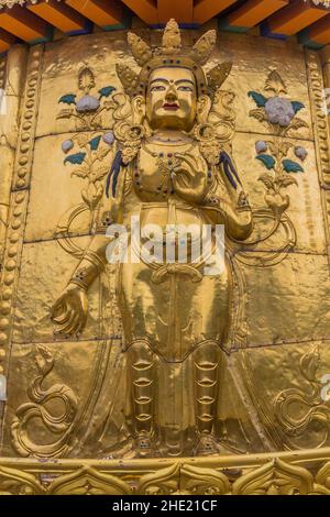 XIAHE, CHINA - AUGUST 25, 2018: Golden Buddha relief at Gongtang pagoda at Labrang monastery in Xiahe town, Gansu province, China Stock Photo