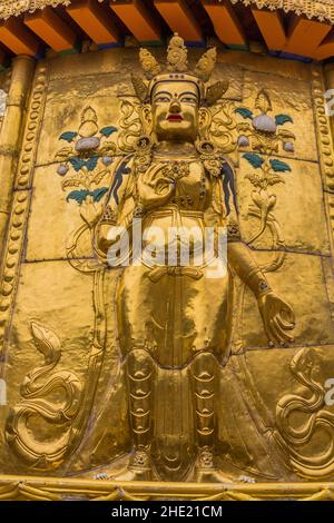 XIAHE, CHINA - AUGUST 25, 2018: Golden Buddha relief at Gongtang pagoda at Labrang monastery in Xiahe town, Gansu province, China Stock Photo