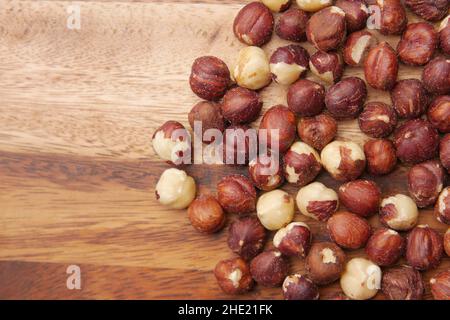 hazelnuts in a container on black background, Stock Photo