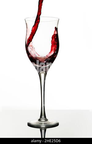 Serving a beautiful glass with red wine. White background, Glass cup. Elegance, good taste, style concept. Stock Photo