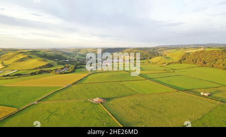 Aerial image of the beach, sea, fields and Llanrhystud Village.  View incudes hills in the background on cloudy day Stock Photo