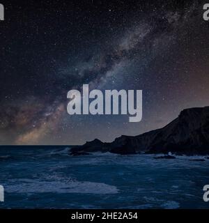 Digital composite image of Milky Way night sky over Beautiful landscape image of Hartland Quay in Devon Stock Photo