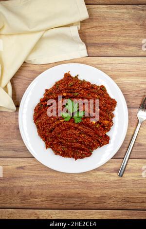 Chili paste on a wooden background. spicy paste. A kind of adjika. Turkish cuisine appetizers. Top view. Close up