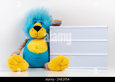 Empty lightbox with lion toy on white table. Mockup concept. Stock Photo