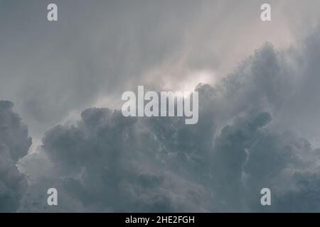autumn gray sky with clouds. Cloudiness formed before thunderstorm. Dramatic storm clouds, gray with sunburst skylights Stock Photo