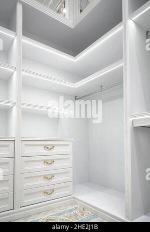 Vertical Spacious walk in closet of new home with metal rods shelves ...
