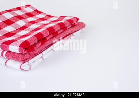 Folded red checkered picnic kitchen towels on grey Stock Photo