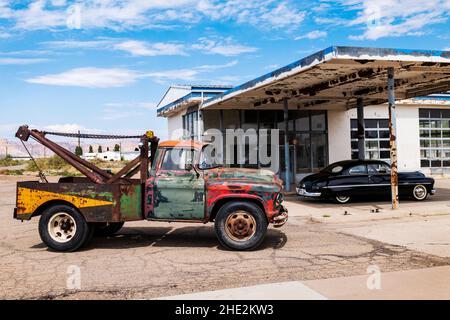 Rusted antique Chevrolet tow truck; Beautifully restored black Mercury automobile; Green River; Utah; USA Stock Photo