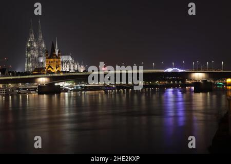 Cologne skyline with crane houses, dome and Rhine in the night Stock Photo
