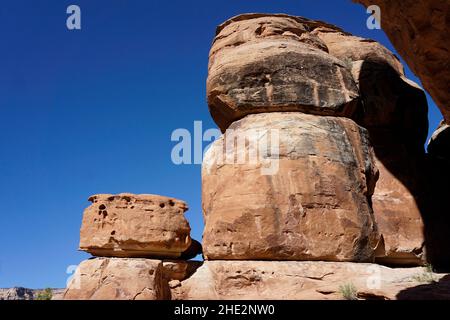 Stacks of red rocks in Colorado National Monument against a clear blue sky Stock Photo