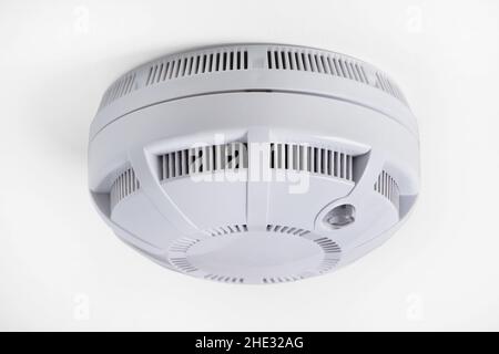 Ceiling smoke detector close up on white Stock Photo