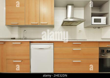 Modern kitchen with large cabinets with drawers in cherry color combined with gray color Stock Photo